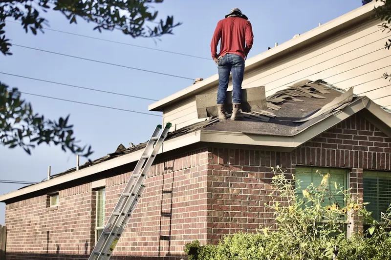 Professional roofer working on a residential roof in Kamas